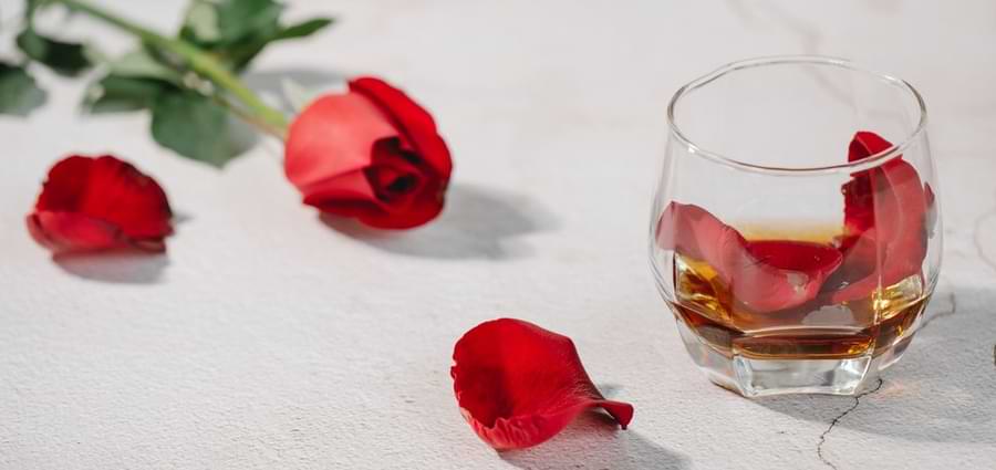 rose petals in glass of cognac